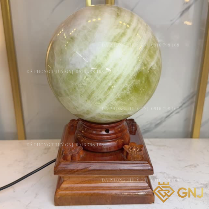 Quả Bi Cầu Đá Thạch Anh Vàng Tự Nhiên — trên đế gỗ bậc thang, tông xanh vàng nhạt