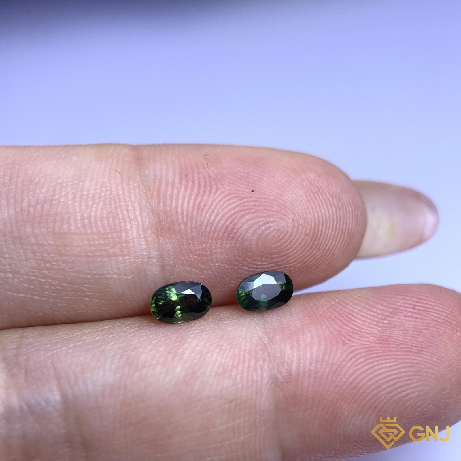 Cặp đá sapphire xanh lá tự nhiên 0,50ct (2 viên) - trên tay