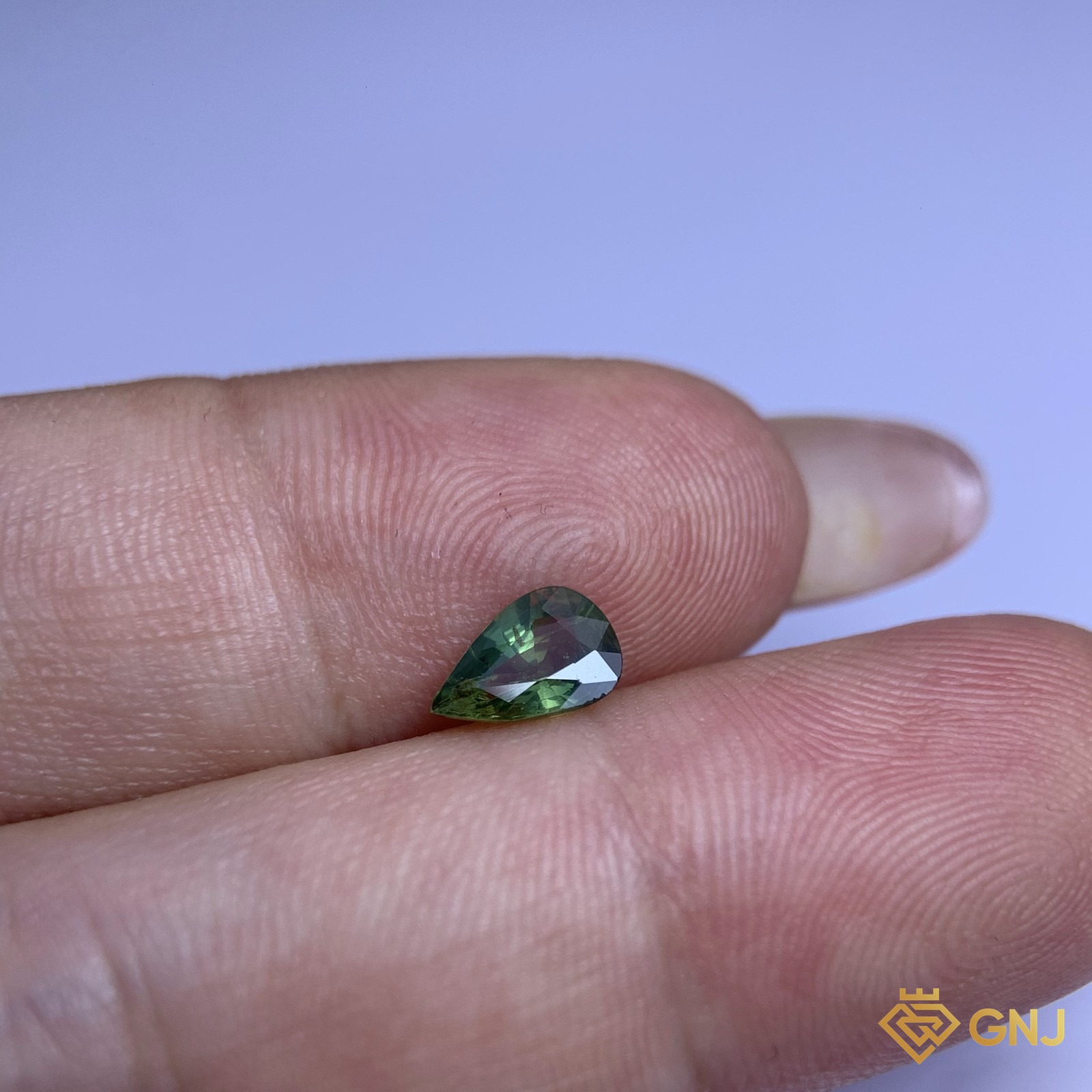 Đá sapphire xanh lá tự nhiên 0,79ct - trên tay
