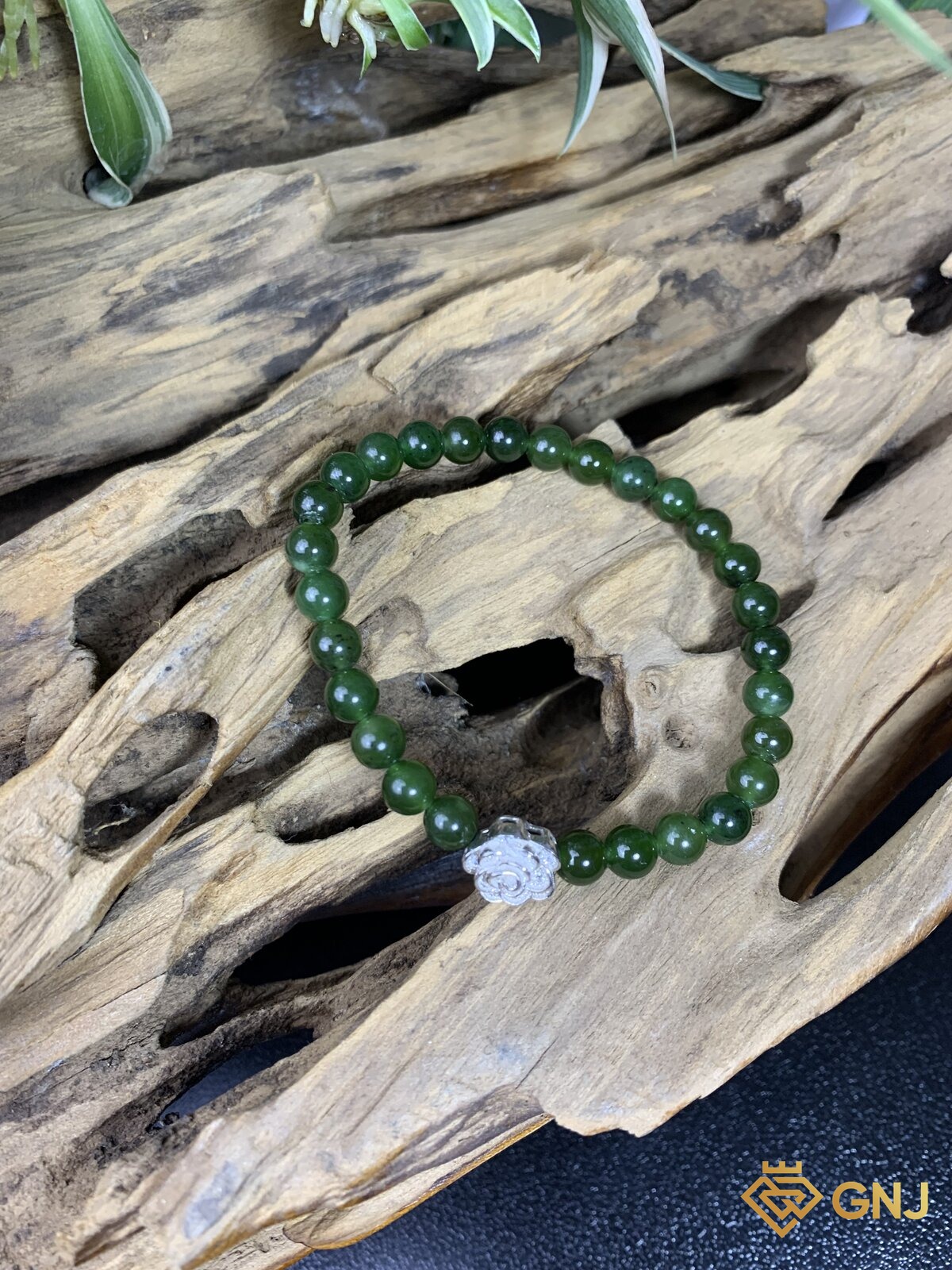 Vòng tay ngọc bích nephrite charm hoa bạc — góc nghiêng, ngọc bích tự nhiên xanh rêu