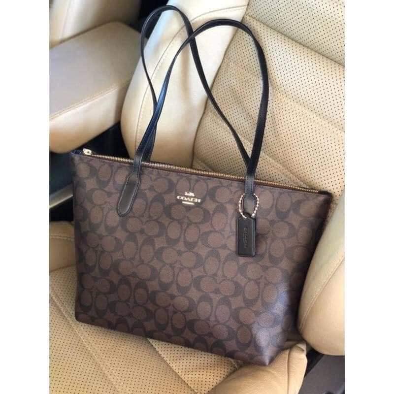 túi coach zip top tote in signature canvas màu nâu đen