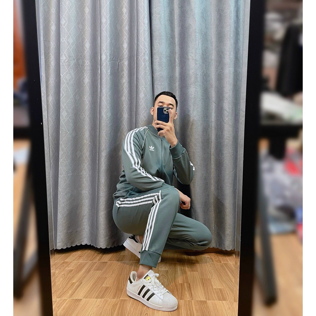Bộ Quần Áo Thể Thao Unisex Nam Nữ Adidas Adicolor Classic Primeblue SST Track - Màu Xi Măng