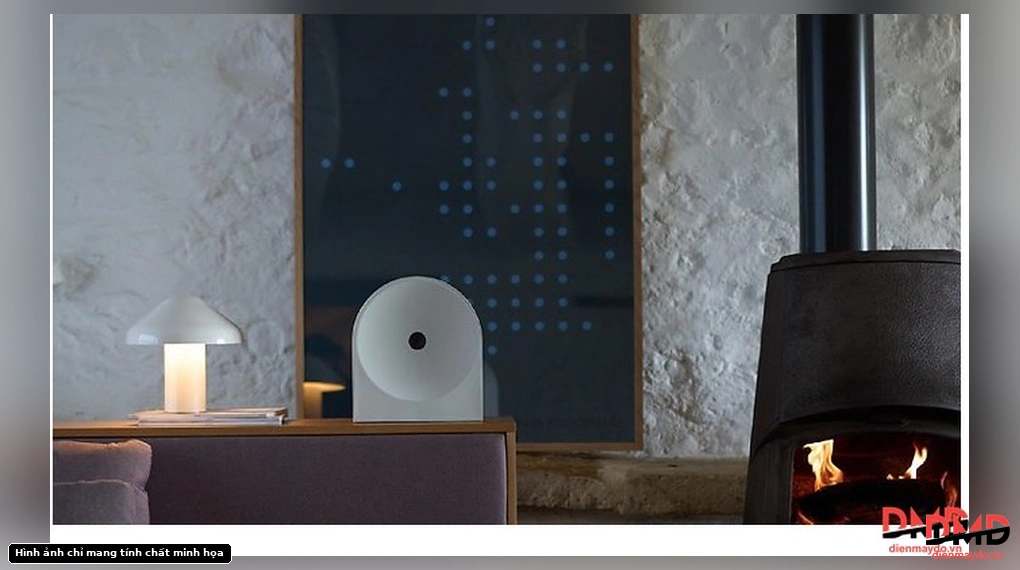 Samsung Music Studio 5 HW-LS50H/XV 70W white speaker in a living room setting next to a fireplace