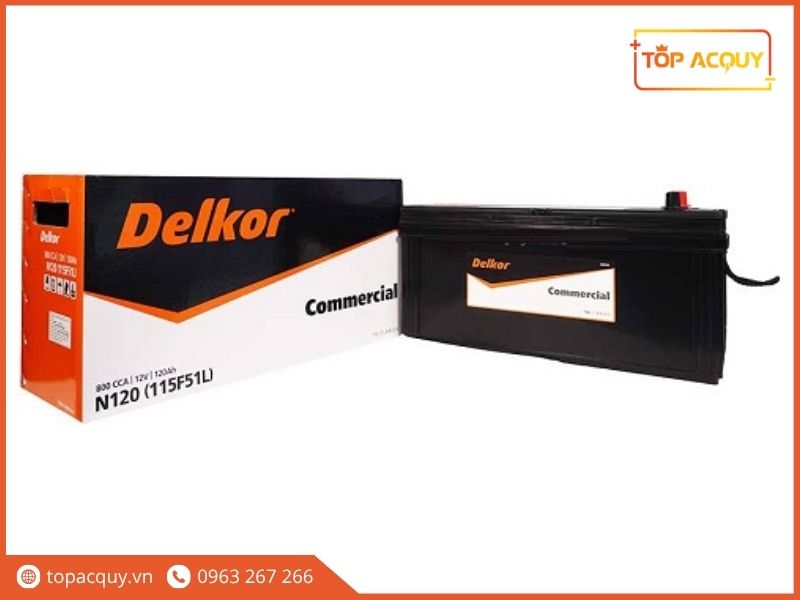 Bình ắc quy Delkor Commercial N120 (115F51L) 12V - 120Ah 800CCA nguyên kiện đặt cạnh thùng carton đóng gói chính hãng