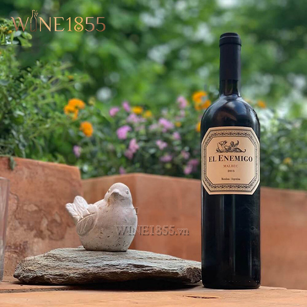 Chai El Enemigo Malbec chụp trong không gian sân vườn thiên nhiên