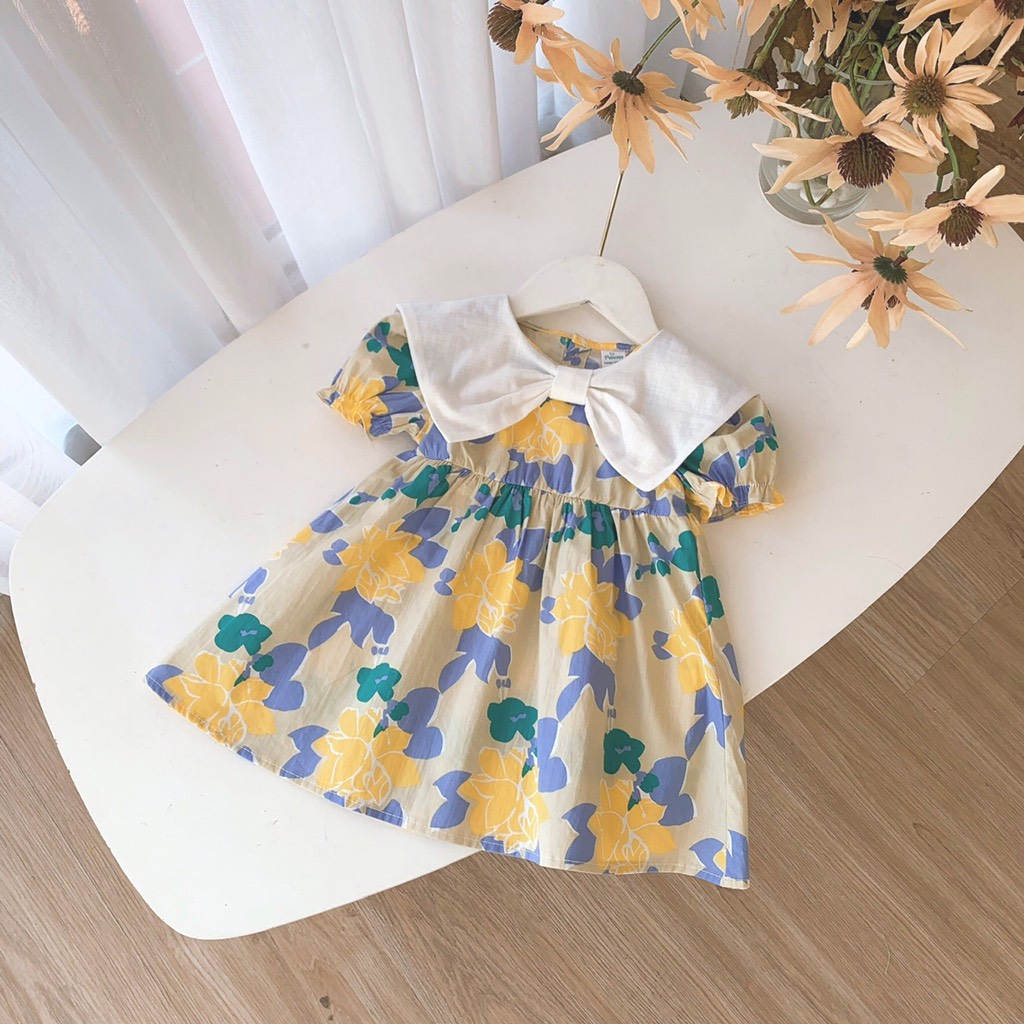 Đầm hoa phối cổ nơ trắng Op Kids