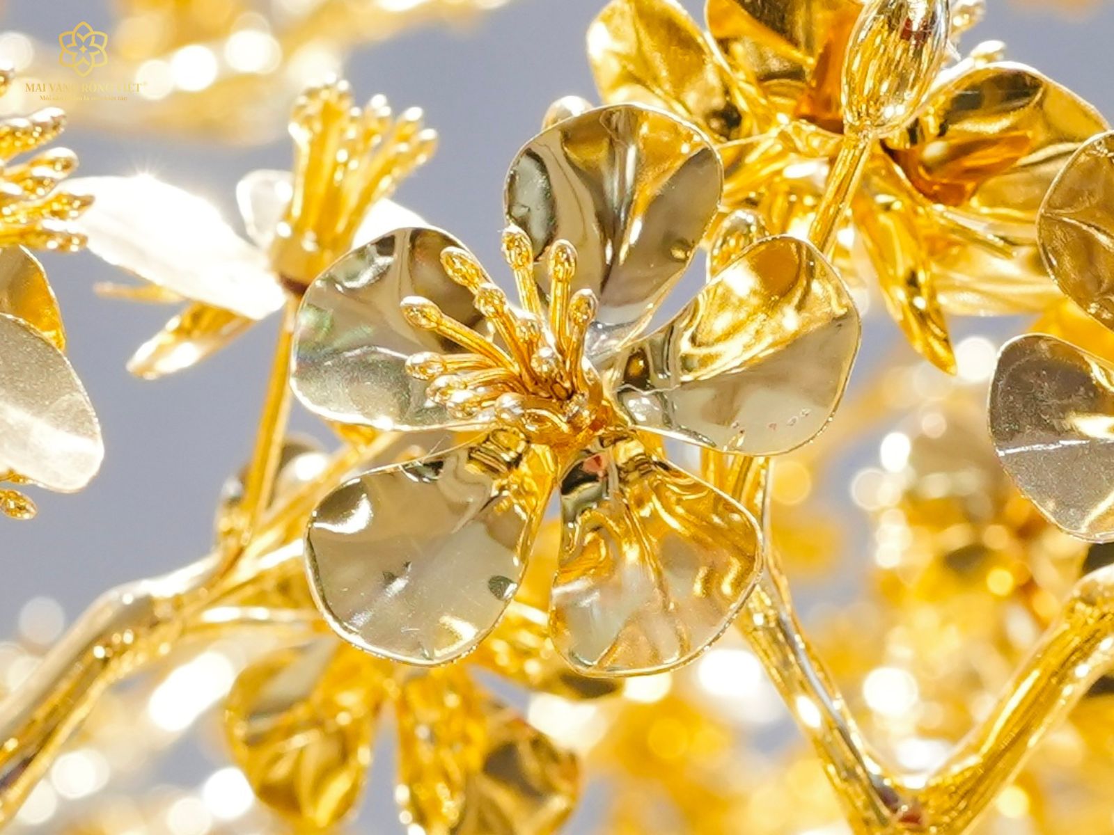 Hoa mai được tạo hình nở tròn, cánh xếp lớp mềm mại cùng nhụy hoa bắt sáng mạnh