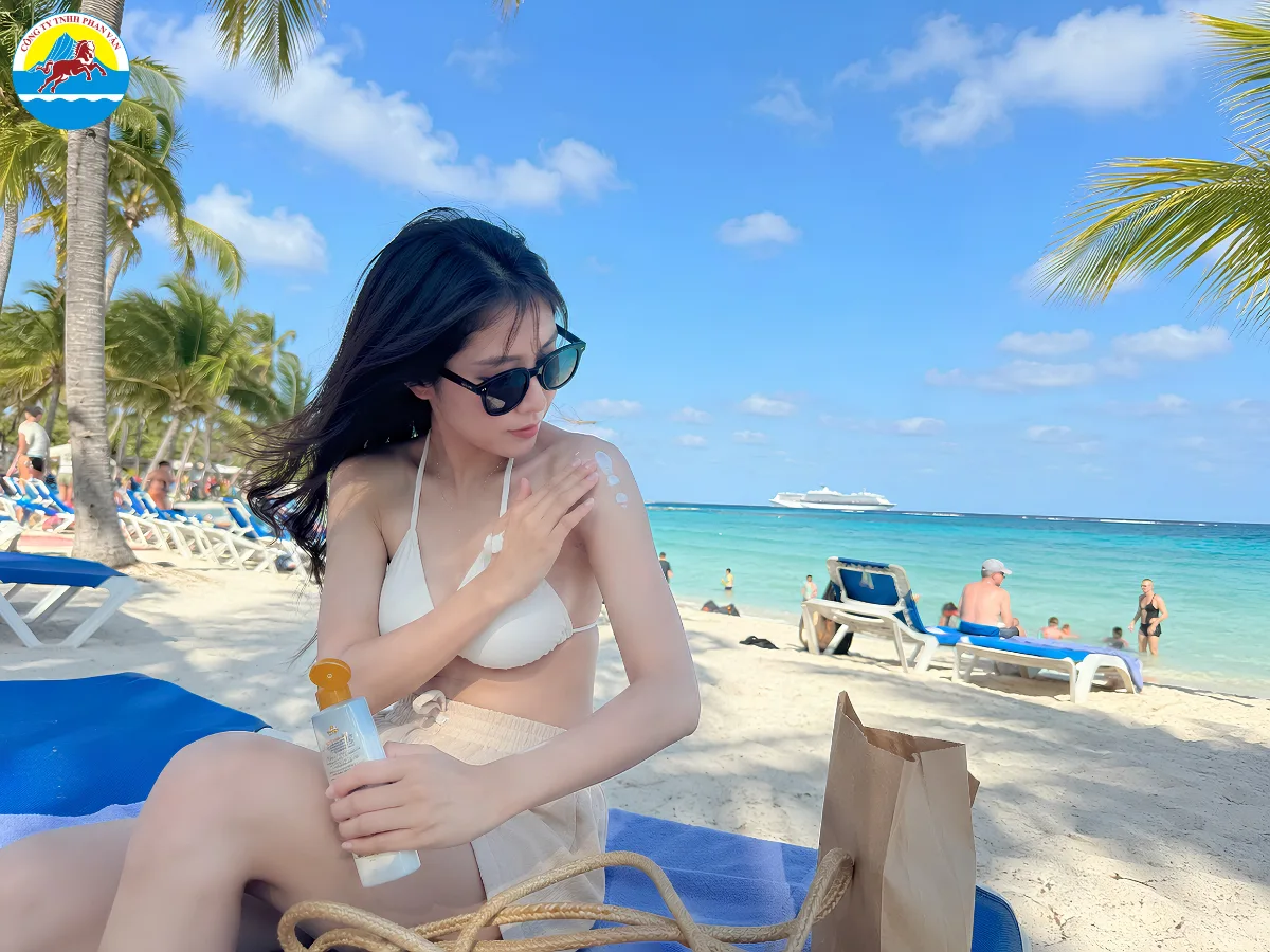 Du khách thoa kem chống nắng trước khi tắm biển tại Caribe