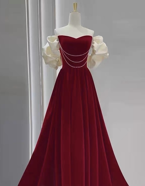 Red velvet one-shoulder dress for brides, weddings, and engagement ceremonies — a simple yet elegant pearl wedding gown. R4000