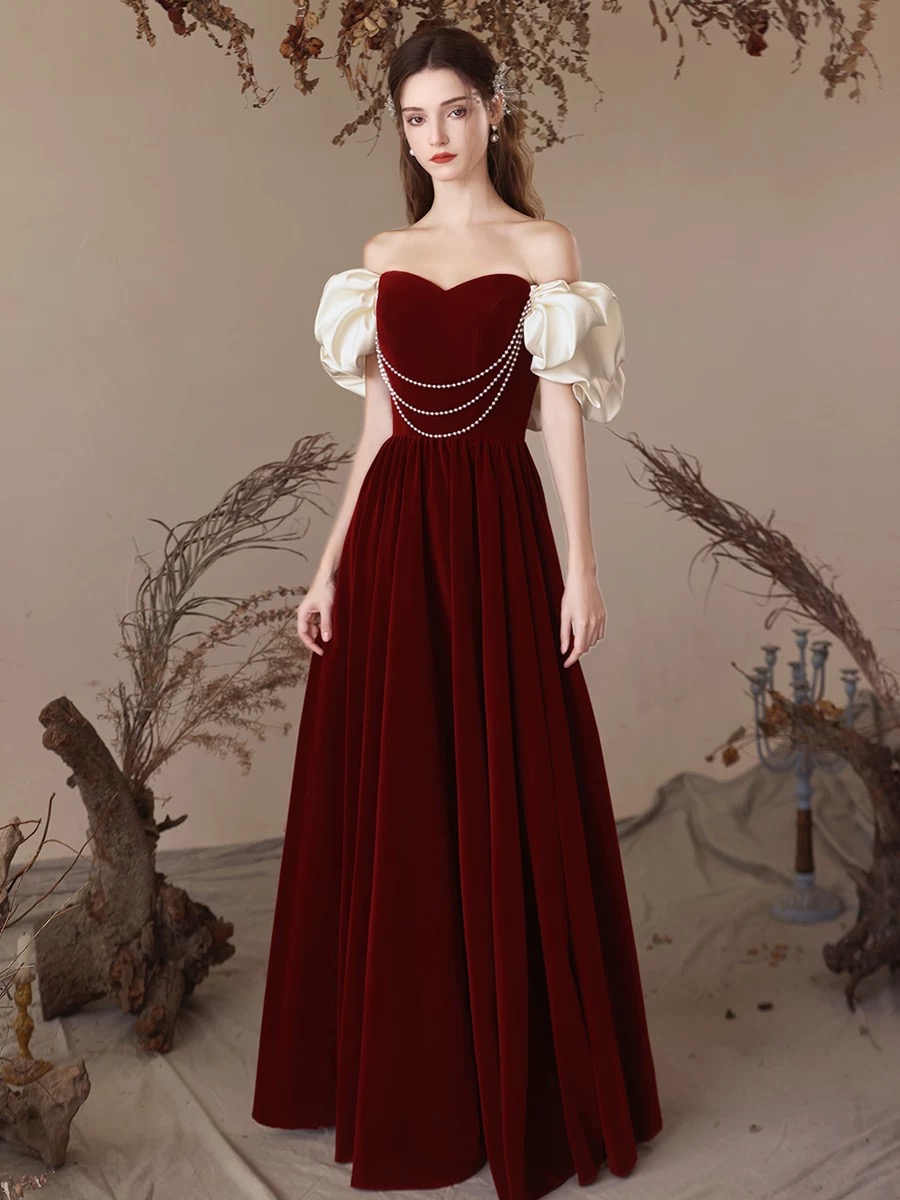 Red velvet one-shoulder dress for brides, weddings, and engagement ceremonies — a simple yet elegant pearl wedding gown. R4000