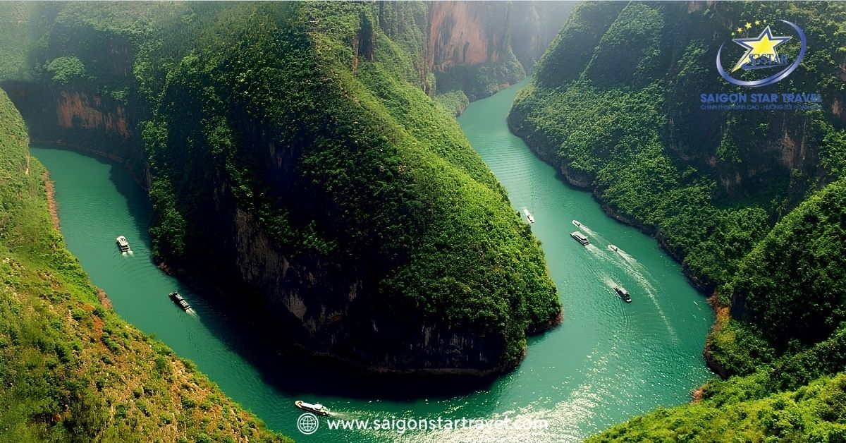 Dòng sông Nho Quế uốn lượn mềm mại quanh vách núi đá vôi, nhìn từ trên cao tựa như một dải lụa xanh ngọc bích tuyệt đẹp.