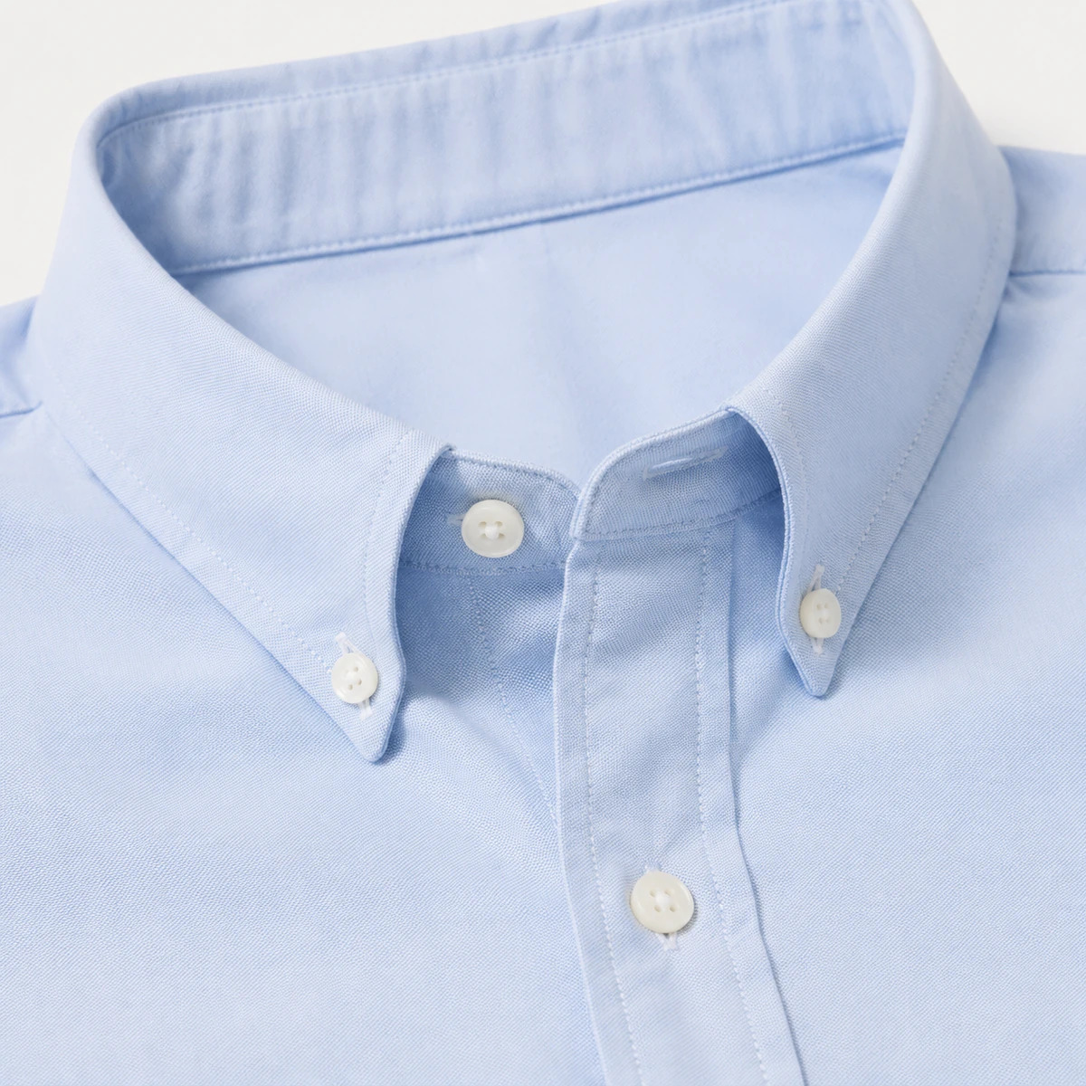 Light-blue woven shirt collar and button-placket reference