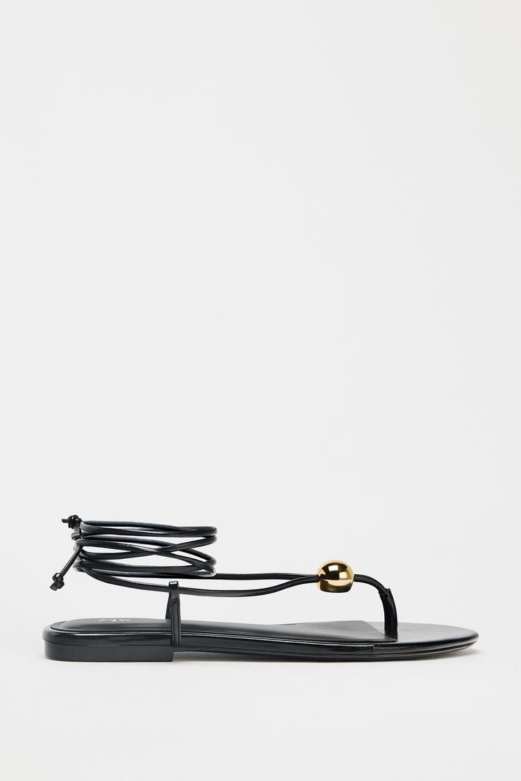 FLAT SANDALS WITH METALLIC APPLIQUÉ