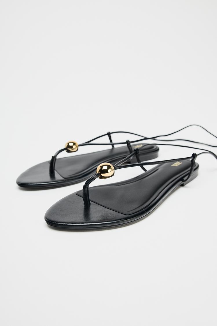 FLAT SANDALS WITH METALLIC APPLIQUÉ