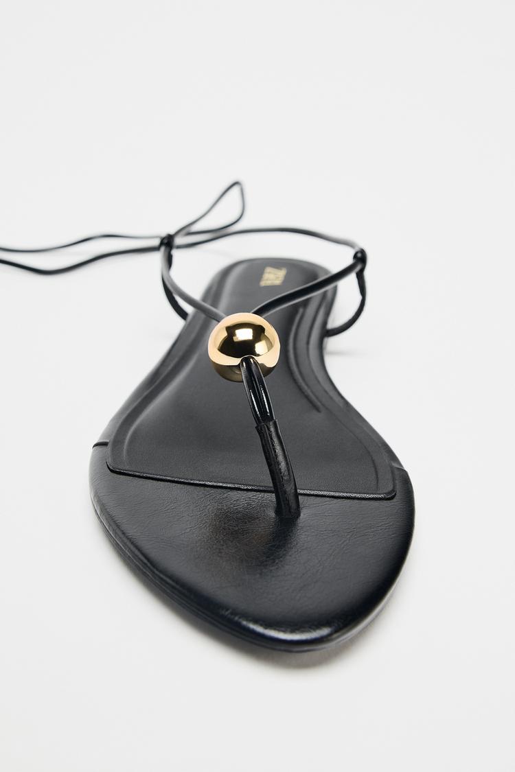 FLAT SANDALS WITH METALLIC APPLIQUÉ