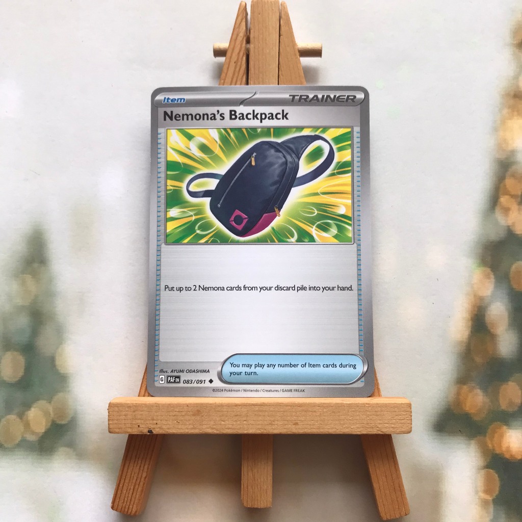 Thẻ hình Pokemon Nemona's Backpack 083/091 - Lá bài lẻ Paldean Fates Uncommon Reverse Holo tiếng Anh chính hãng