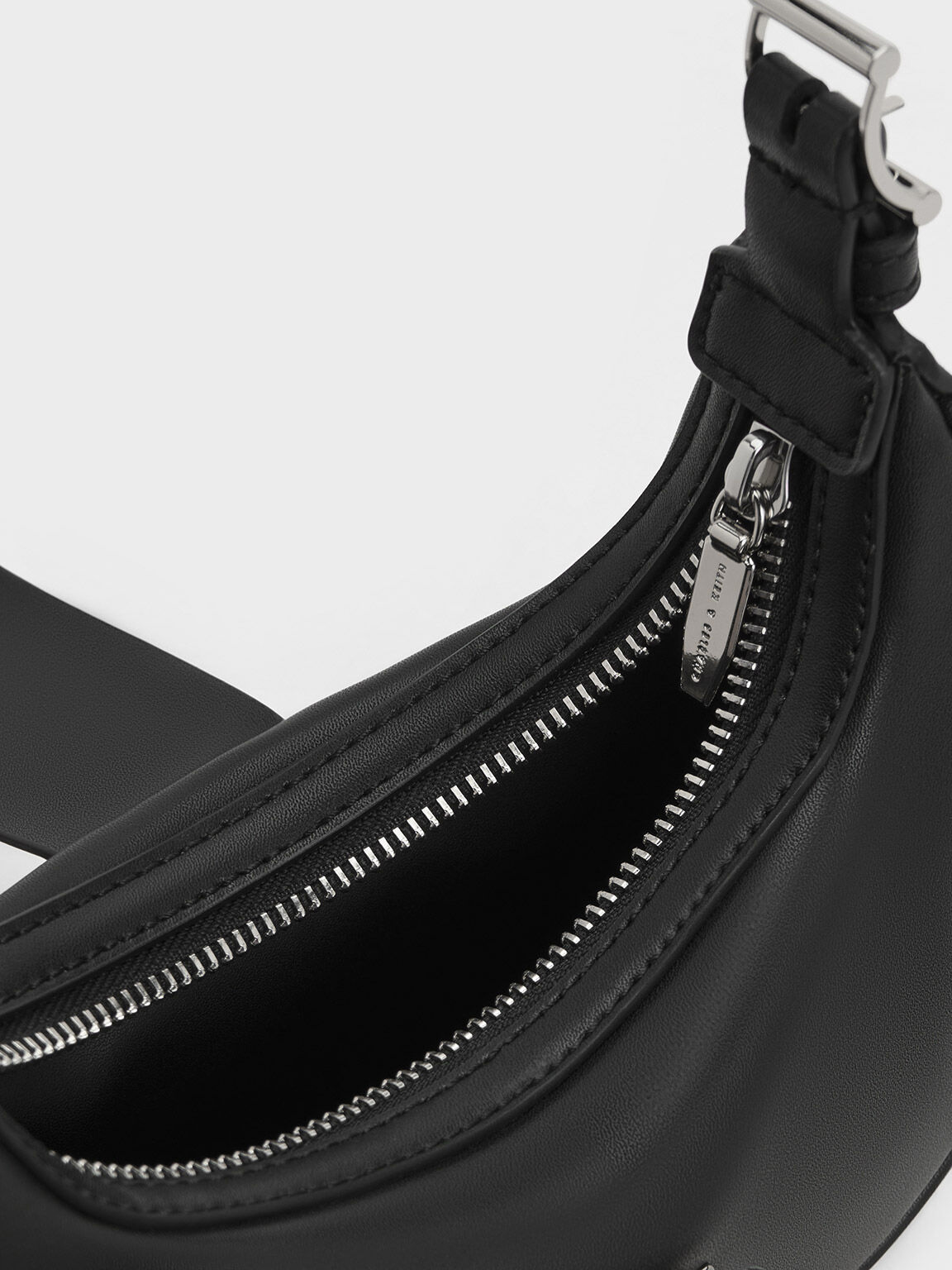 Trice Metallic Accent Belted Curved Shoulder Bag
