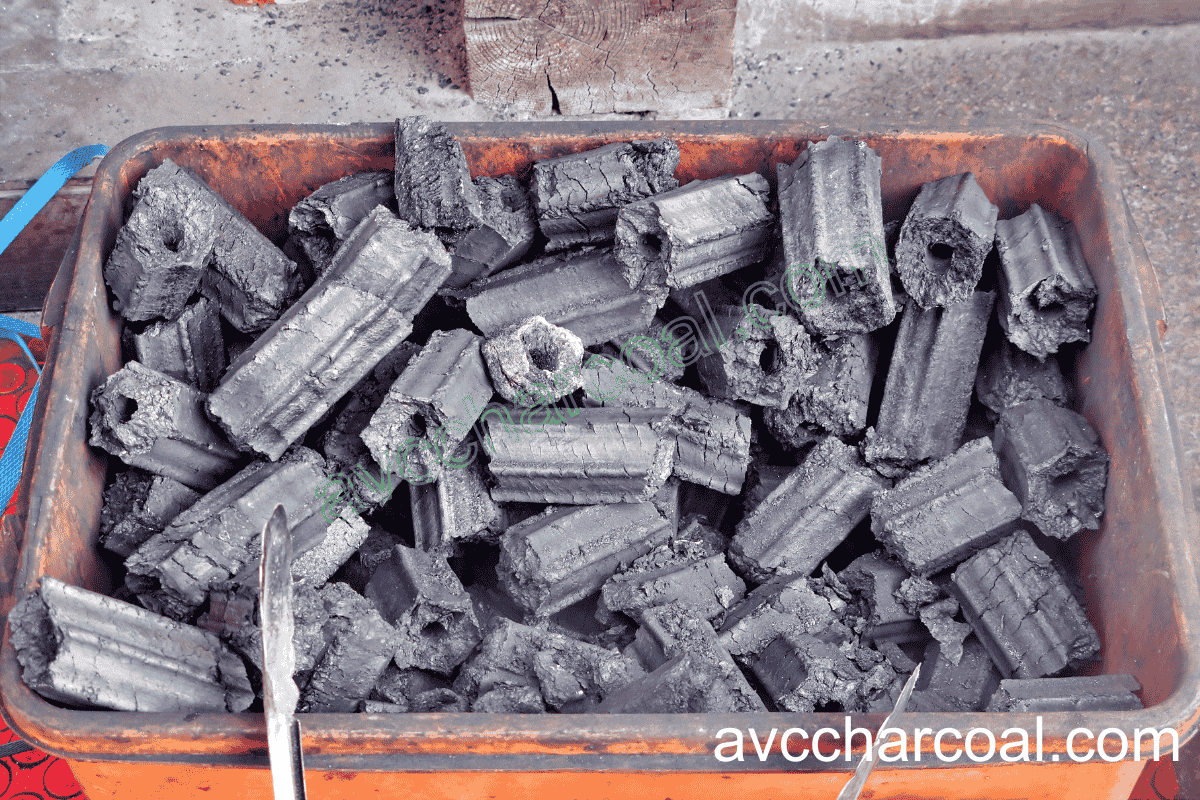 Someone safely disposing of cooled charcoal ashes into a metal container to prevent fire hazards
