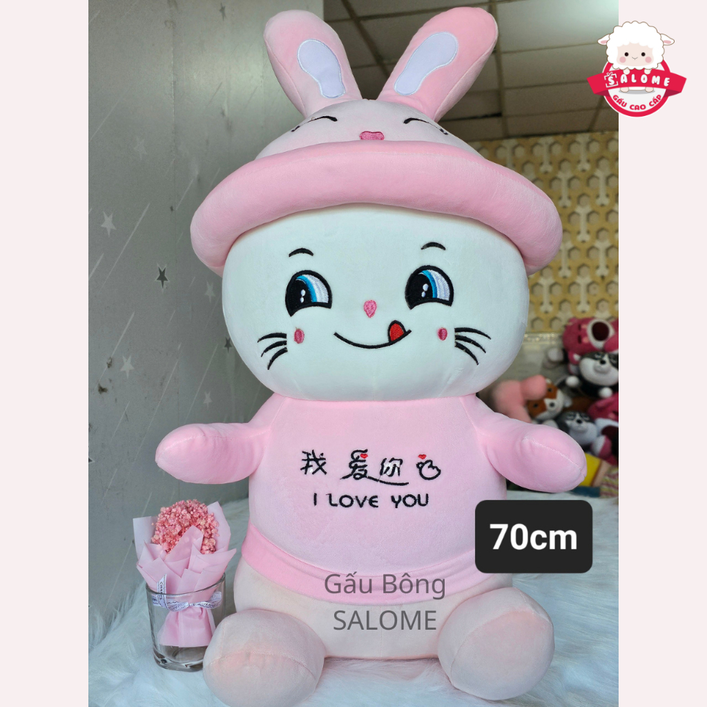 Gấu Bông Mèo Ngồi Mắt Liếc Đội Mũ Thỏ Khổng Lồ Dễ Thương SALOME Thú Bông Mèo Hồng Liếm Mép Ôm Ngủ