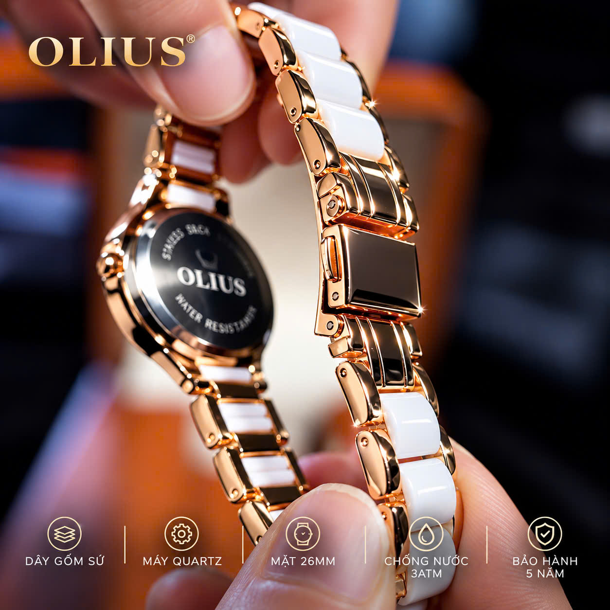 ĐỒNG HỒ NỮ OLIUS 28MM VÀNG HỒNG MẶT TRẮNG – DÂY GỐM SỨ – ĐÍNH ĐÁ PHA LÊ – MÁY QUARTZ