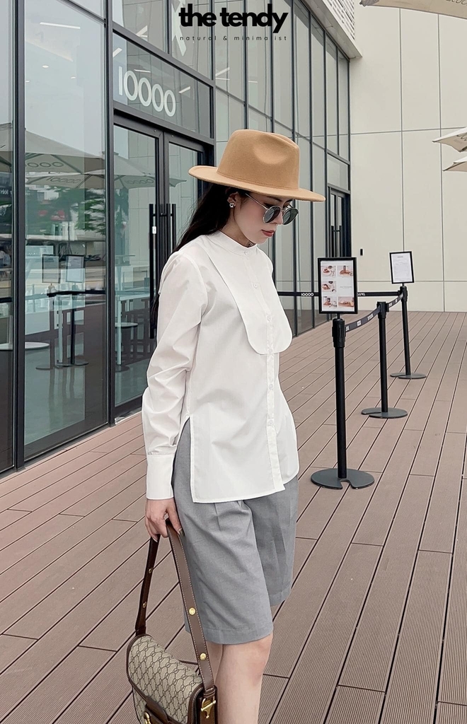 Áo sơ mi Lyla màu trắng, cổ tàu, có măng séc cài 2 cúc, phối cách điệu sau lưng