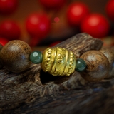 Vòng tay Trầm Hương tròn 12 li cận chìm mix Lu Thống vàng 24k