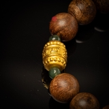 Vòng tay Trầm Hương tròn 12 li cận chìm mix Lu Thống vàng 24k