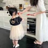 Đầm xoè đen nơ lưng