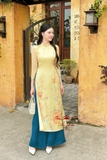 Áo dài tơ vàng mơ kết hoa, quần xanh