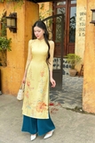 Áo dài tơ vàng mơ kết hoa, quần xanh