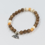 VÒNG TRẦM NỮ PHỐI CHARM HOA SEN BẠC VÀ ĐÁ SÒ HOÁ THẠCH