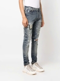 AMIRI Varsity ripped skinny jeans