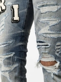 AMIRI Varsity ripped skinny jeans