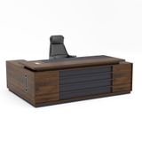 Bàn Giám Đốc Chữ L BGDY062L màu nâu đậm, hộc tủ hai ngăn kéo bên phải, thiết kế hiện đại với khung đen ánh kim sang trọng dành cho không gian làm việc lãnh đạo.