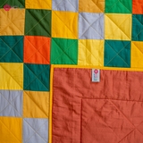 Yellow flower blanket on green grass