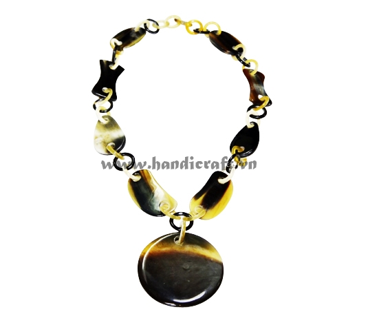 Dark horn with large round pendant