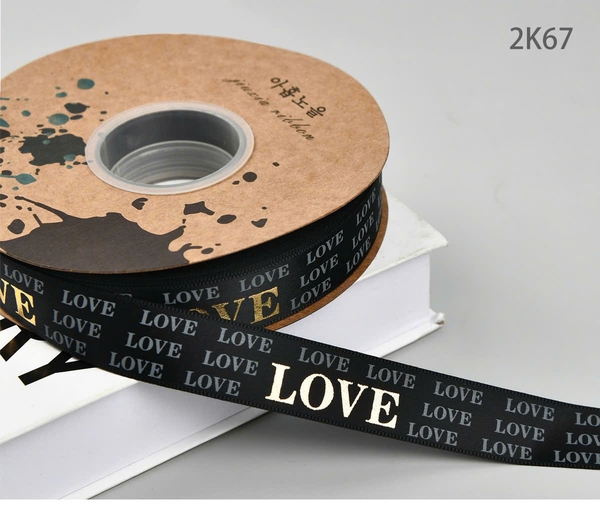 Ruybang vải kt 2.5cmx 35m - chữ LOVE vàng nhũ -nền ĐEN.