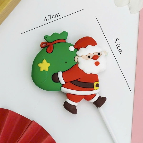 Tượng nhựa dẻo-Ông già noel cõng túi quà xanh.