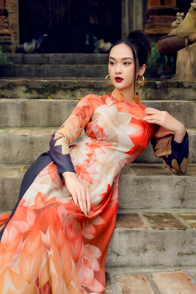 Traditional Vietnamese dress with orange lotus pattern