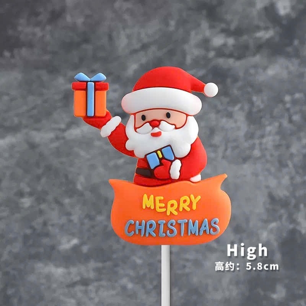Tượng nhựa dẻo-Ông già noel tay cầm hộp quà và chữ XMas màu cam.