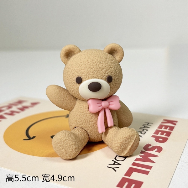 Tượng gấu nâu nhạt-cài nơ màu hồng.