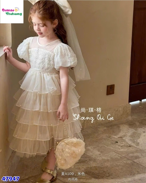 Đầm tiệc kem tầng đính nơ