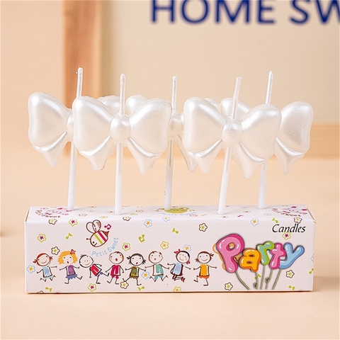 Vỉ 5 cây nến hình nơ màu TRẮNG.