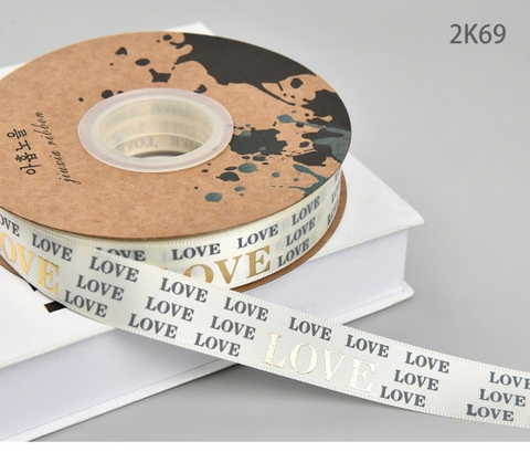 Ruybang vải kt 2.5cmx 35m - chữ LOVE vàng nhũ -nền KEM.
