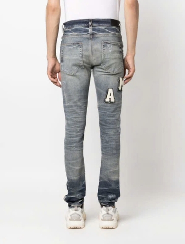 AMIRI Varsity ripped skinny jeans