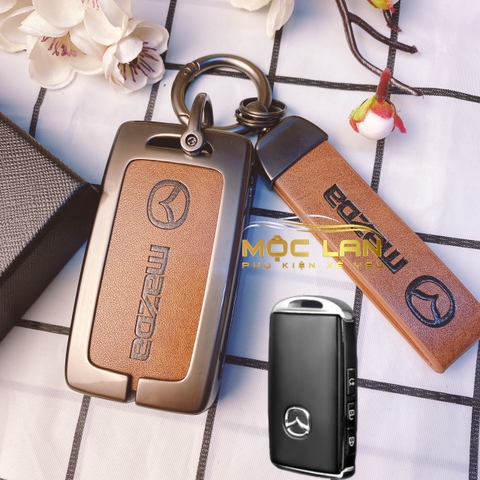 Bộ ốp kim loại mặt da + lưng da bò dập chìm logo mix móc khoá Mazda