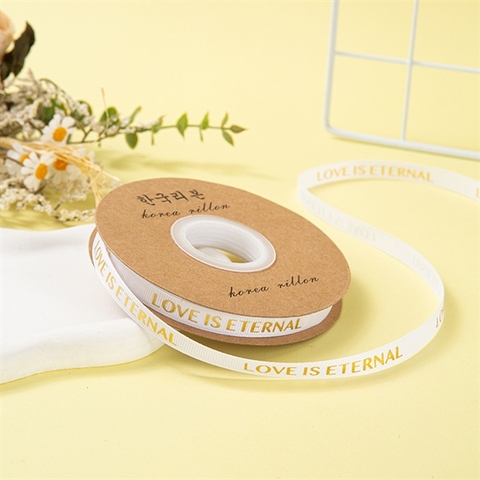 Rb LOVE IS ETERNAL khổ nhỏ 1cm*30m MÀU TRẮNG chữ nhũ vàng