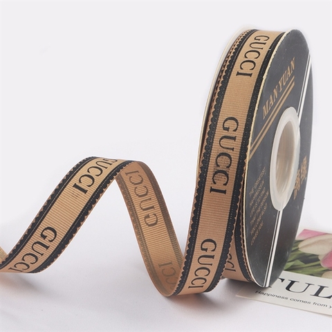 RB GUCCI màu VÀNG ĐỒNG CHỮ ĐEN 2CM*40m