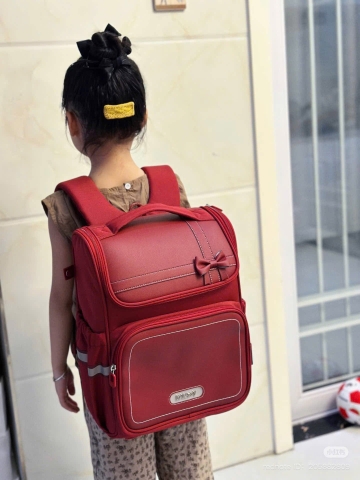 Balo HUACHENG chống gù nơ đỏ size 38x30x20cm