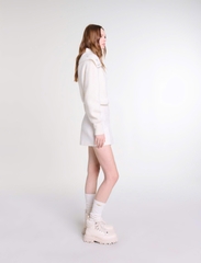 Chân váy Maje xếp ly lệch tweed trắng